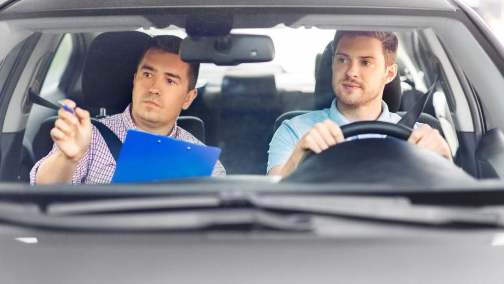 Driving Test With An Instructor Evaluating A Learner