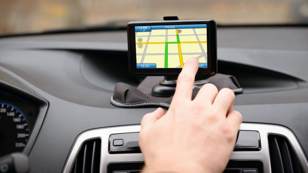 Hand Operating A GPS Navigation Device In A Car