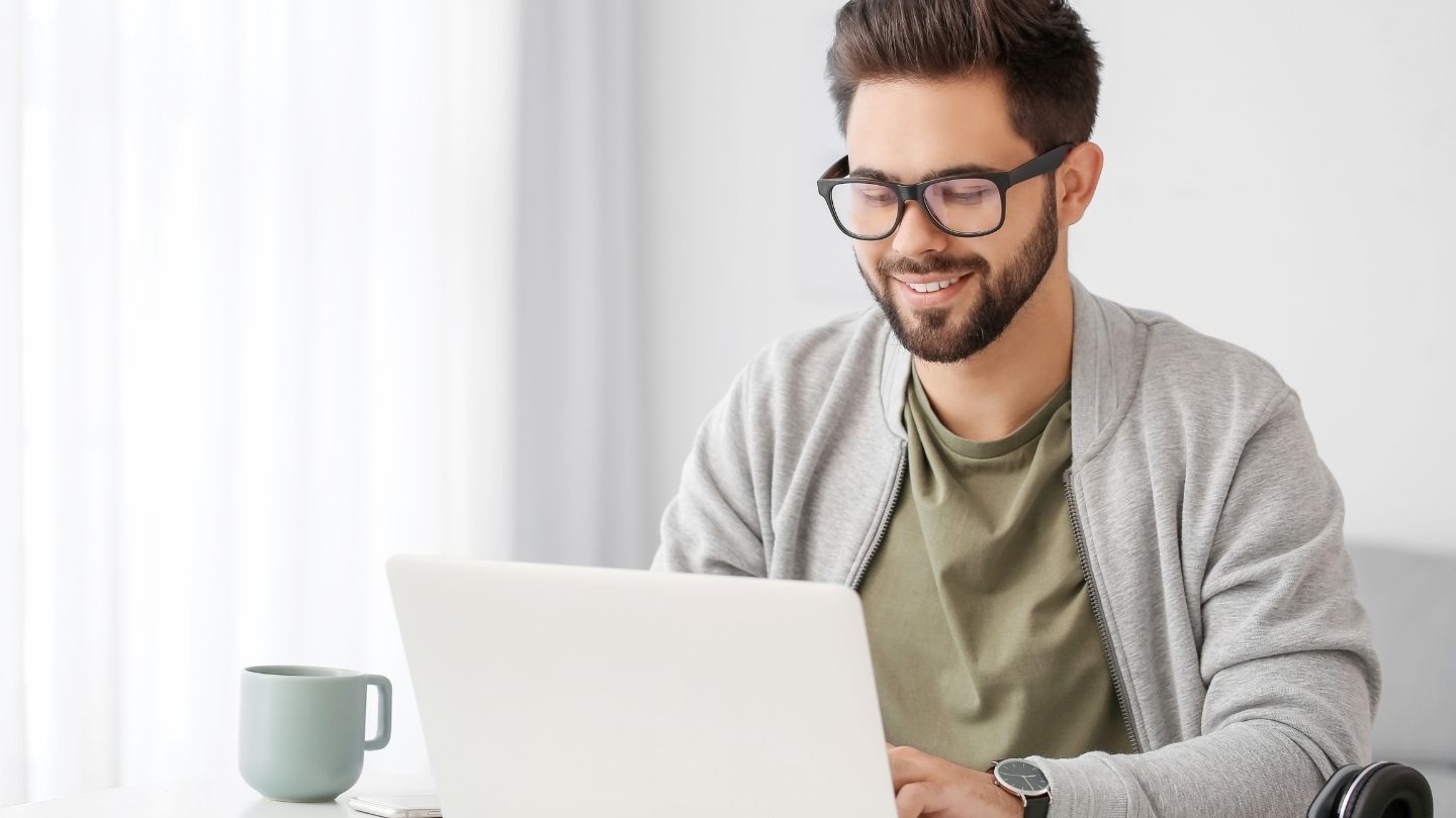 Man Working On A Laptop At Home 