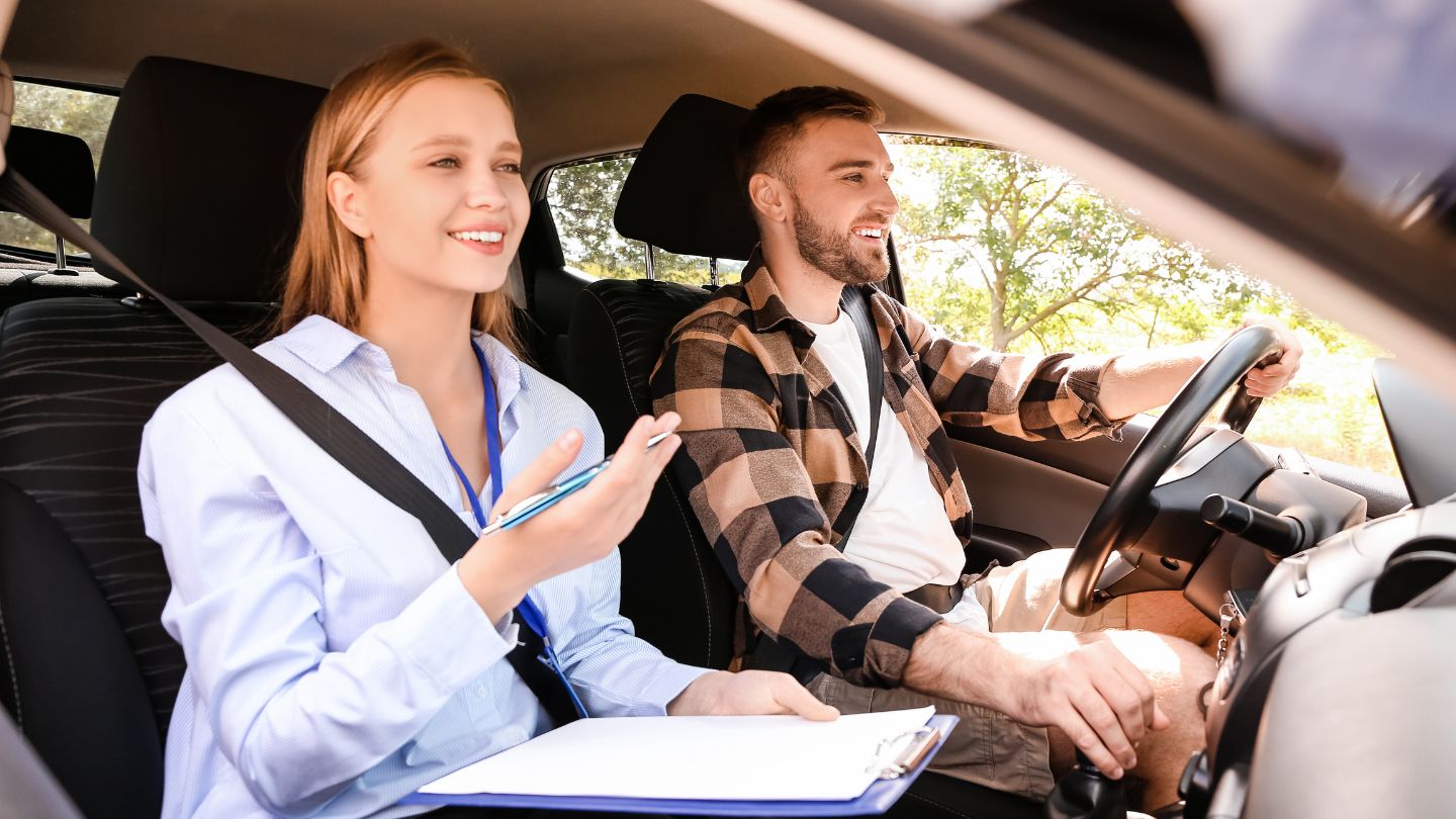 Driving Instructor Guiding A Learner In A Car
