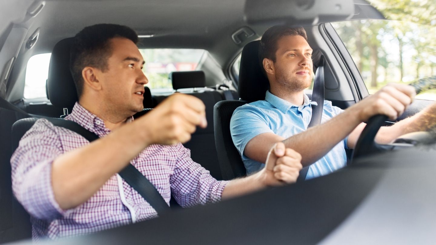 Two Men Talking While Driving In A Car
